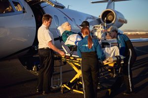 square of elderly patient being transported onto air ambulance