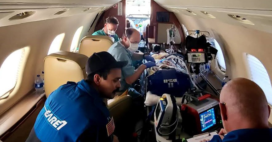 Medical crew caring for medical patient during flight