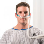 Patient wearing HIFLOW oxygen therapy mask