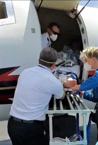 medical professionals transporting patient into the aircraft for medical air transport