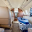 small inside of Learjet facing cabin and showing seats along with stretcher